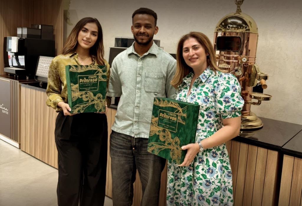 Maryam Tabatabaei with two other people holding Prime Rose Farm Ethiopia specialty coffee collection boxes
